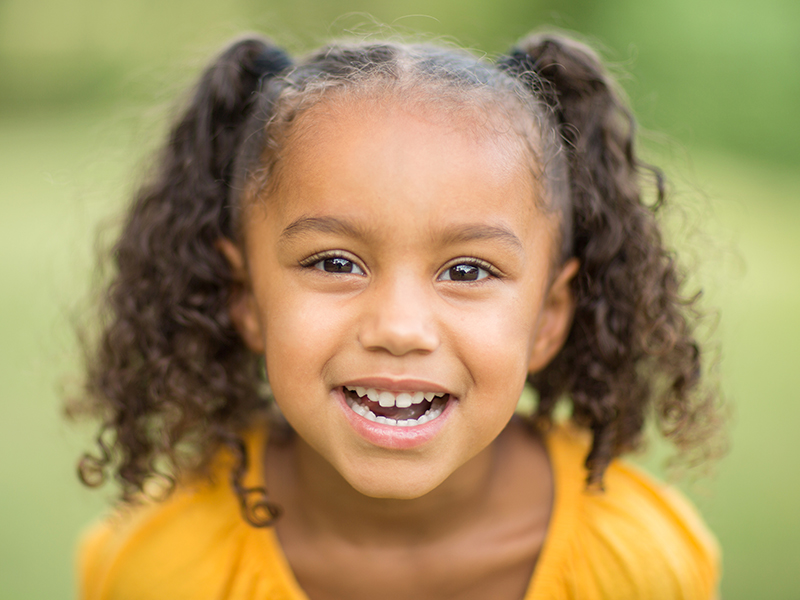 Girl with pig tails smiling